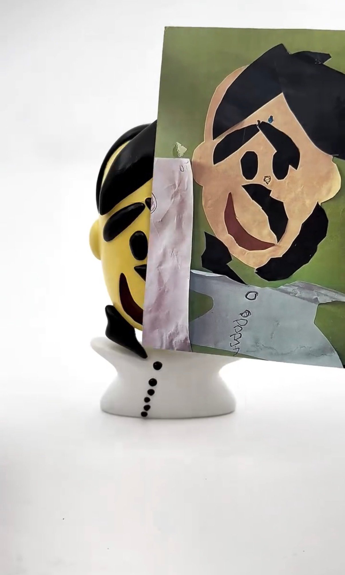 A collage-style portrait bust figurine beside the original cut-paper artwork